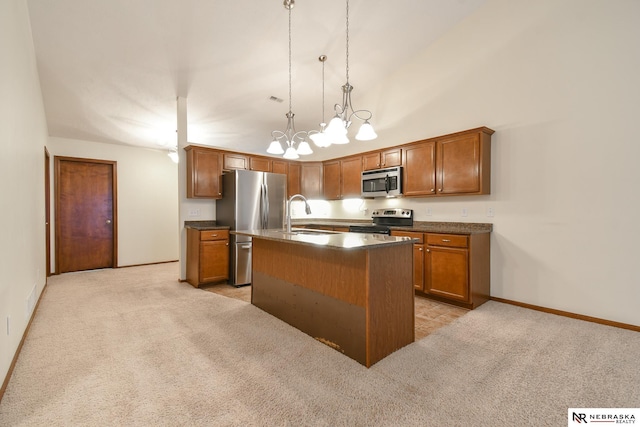 kitchen featuring light carpet, stainless steel appliances, sink, a center island with sink, and hanging light fixtures