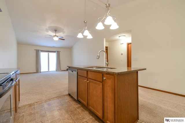 kitchen featuring sink, hanging light fixtures, lofted ceiling, light carpet, and appliances with stainless steel finishes