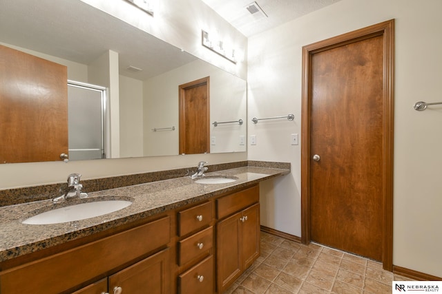 bathroom with vanity and a shower with shower door