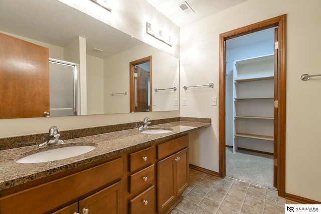 bathroom with vanity and an enclosed shower