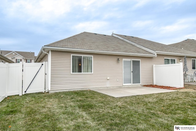 rear view of house with a yard and a patio