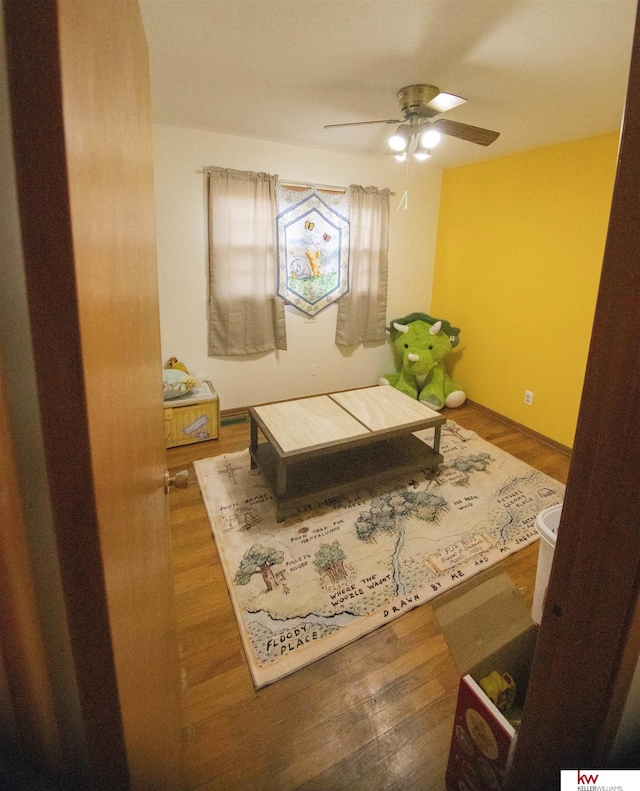 interior space with ceiling fan and dark hardwood / wood-style floors