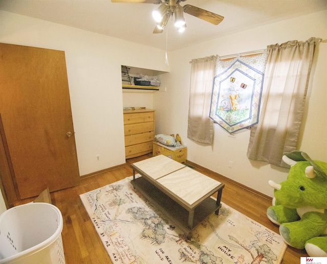 sitting room featuring ceiling fan and hardwood / wood-style flooring