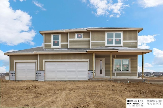 prairie-style home with covered porch and a garage