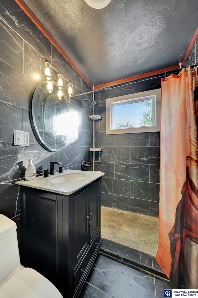 bathroom featuring a shower with curtain, vanity, toilet, and tile walls