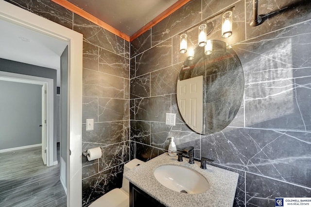 bathroom featuring vanity, tile walls, and hardwood / wood-style flooring