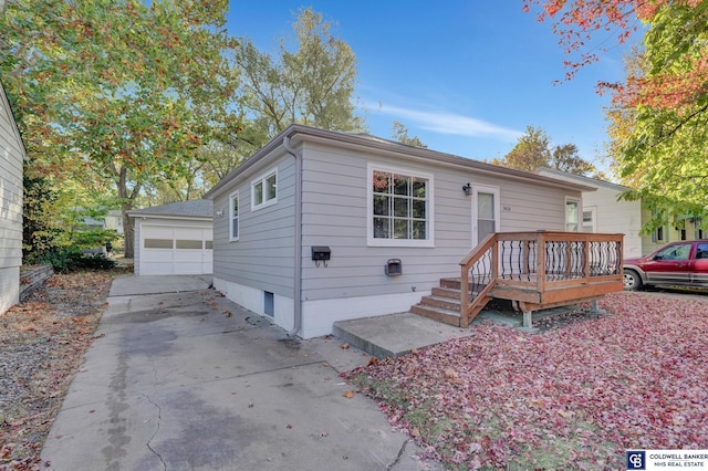 view of front of home featuring an outdoor structure, a deck, and a garage