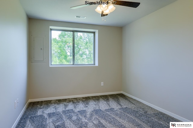 carpeted spare room featuring electric panel and ceiling fan