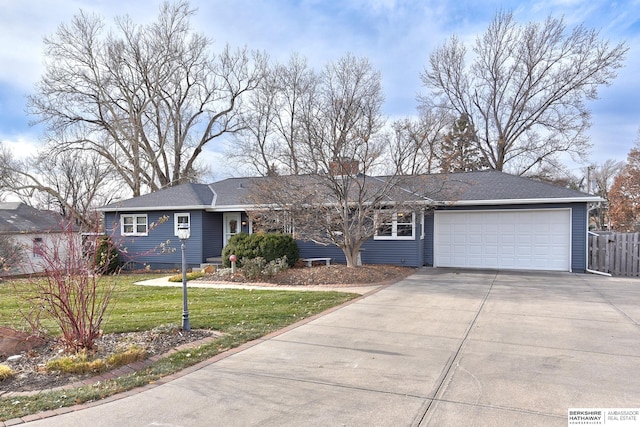 ranch-style house with a garage and a front lawn