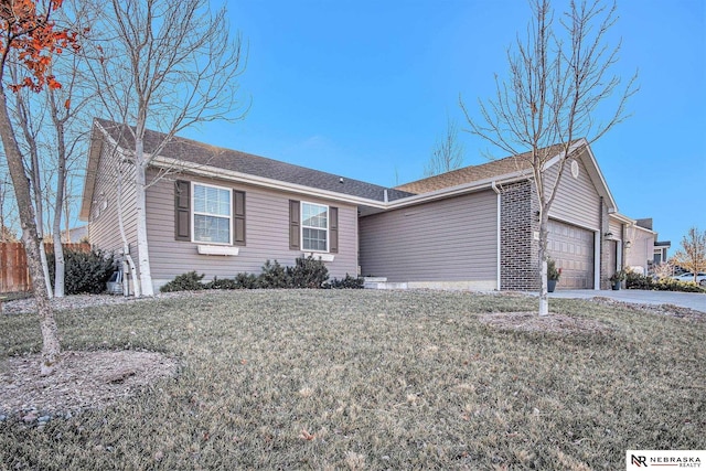 single story home featuring a front yard and a garage