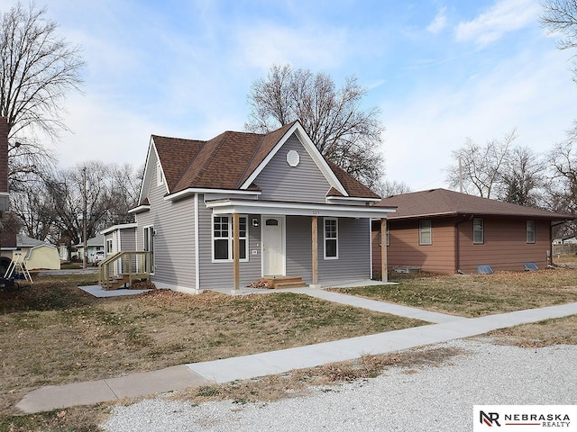 view of front of home with a porch and a front yard