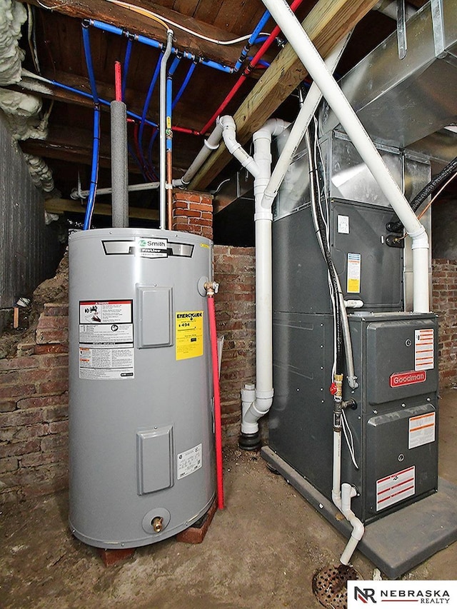 utility room with heating unit and water heater