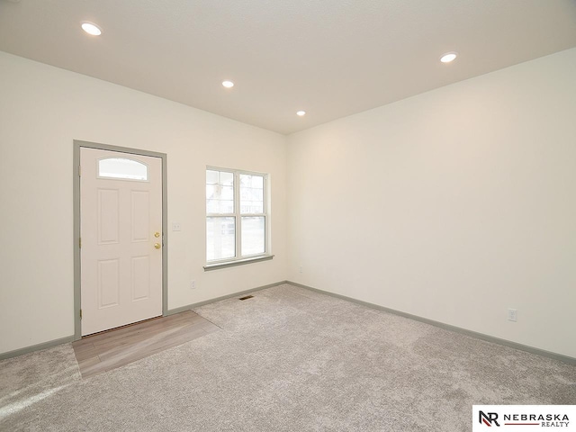 entrance foyer featuring light carpet