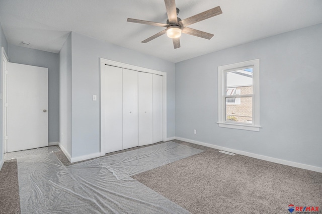 unfurnished bedroom with light carpet, a closet, and ceiling fan