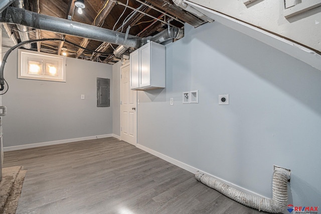 laundry area with hardwood / wood-style flooring, electric dryer hookup, cabinets, and electric panel