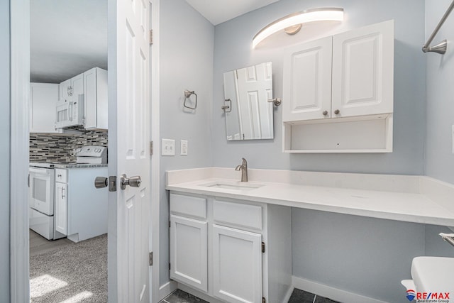 bathroom with vanity and tasteful backsplash