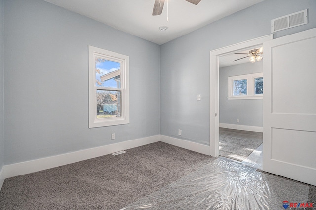 spare room with ceiling fan and carpet