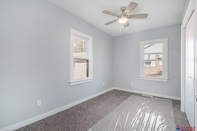 carpeted empty room featuring ceiling fan