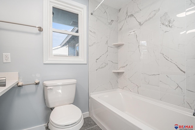 bathroom featuring tile patterned floors, tiled shower / bath combo, and toilet