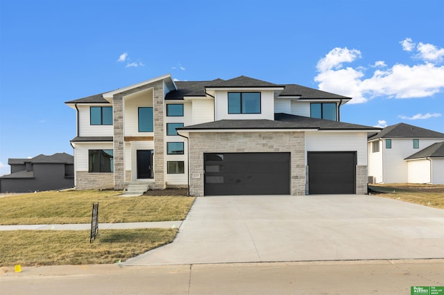 prairie-style home with a garage and a front lawn