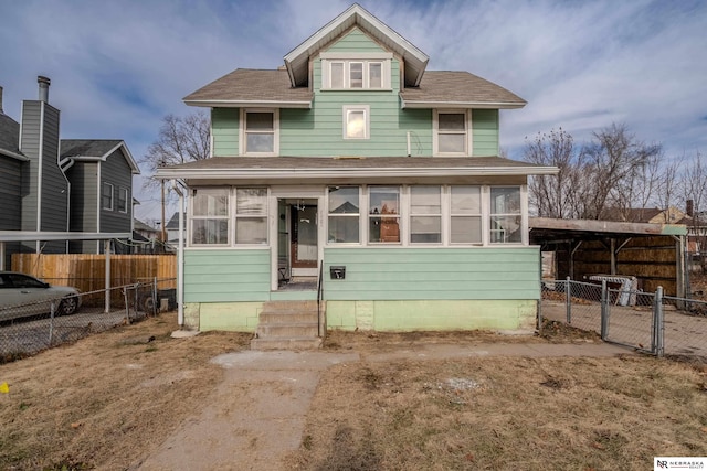 view of front of house with a carport and a sunroom