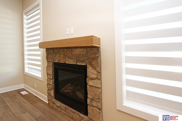 details featuring hardwood / wood-style flooring and a fireplace