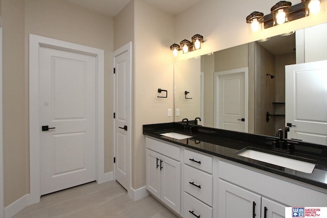 bathroom with vanity and a shower