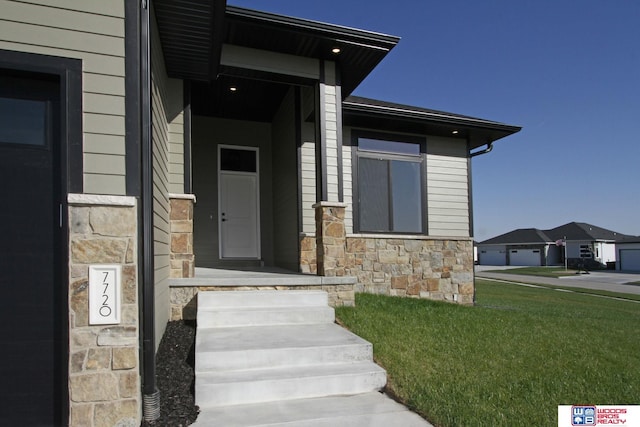 entrance to property featuring a yard