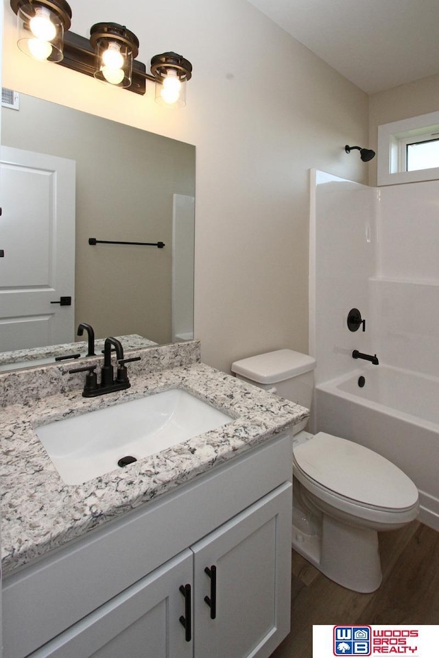 full bathroom featuring vanity, shower / bathtub combination, toilet, and wood-type flooring