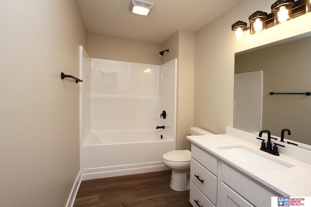 full bathroom featuring wood-type flooring, vanity, toilet, and tub / shower combination