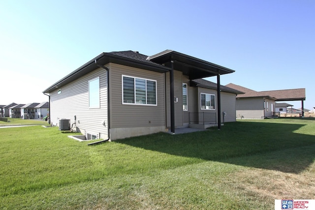 back of property with a yard and cooling unit