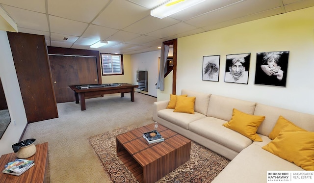 carpeted living room with a paneled ceiling