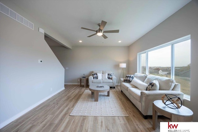 living room with ceiling fan and light wood-type flooring