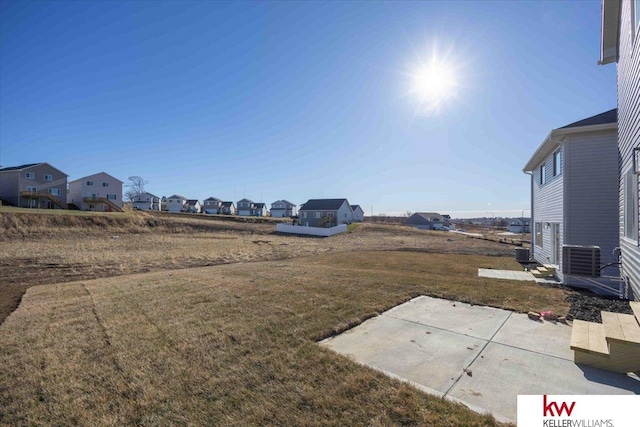 view of yard with a patio area and central air condition unit