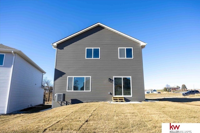 rear view of property with a lawn