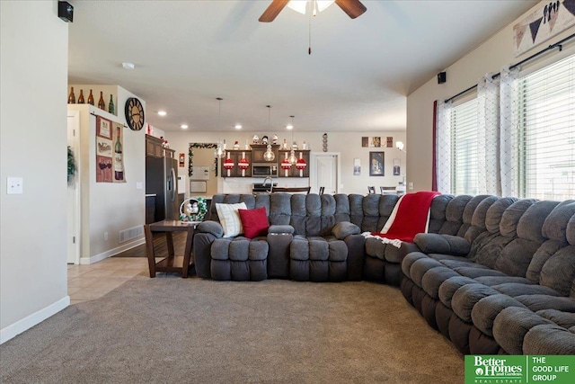 carpeted living room with ceiling fan