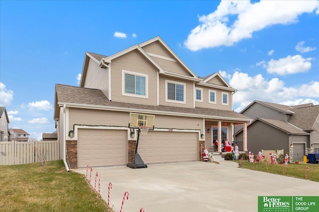 craftsman house with a garage and a front lawn