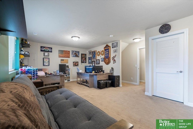 office area featuring a textured ceiling and light colored carpet