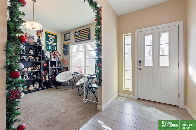 entrance foyer with light tile patterned flooring and a wealth of natural light