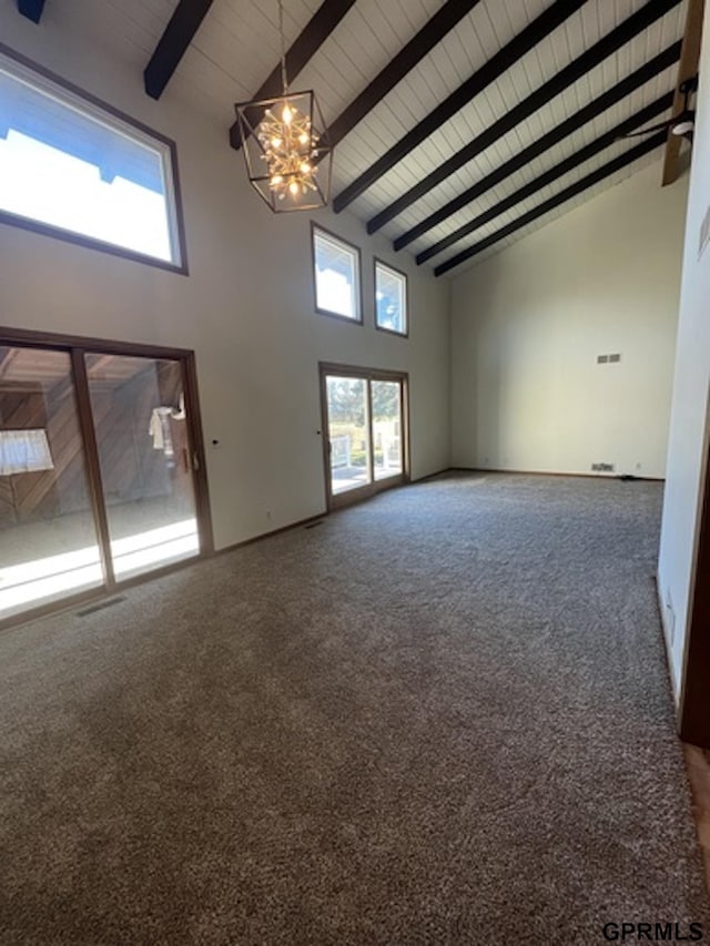 unfurnished living room with carpet flooring, beam ceiling, high vaulted ceiling, a notable chandelier, and wood ceiling