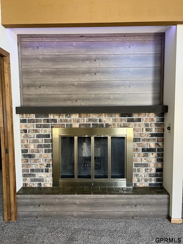 room details with carpet flooring and a brick fireplace