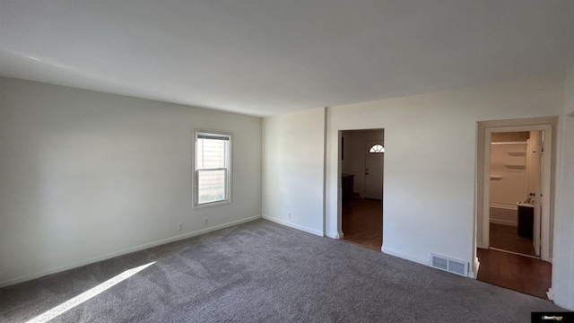 unfurnished bedroom featuring dark carpet