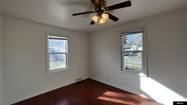 spare room with ceiling fan and dark hardwood / wood-style floors