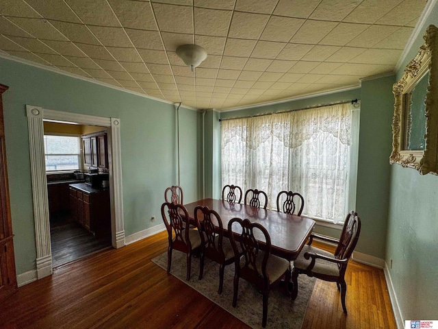 dining area with dark hardwood / wood-style flooring and ornamental molding