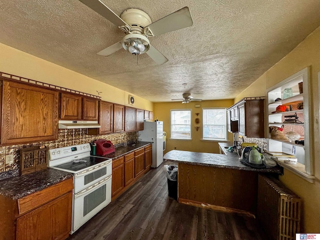 kitchen with radiator heating unit, dark wood-type flooring, backsplash, a textured ceiling, and white appliances