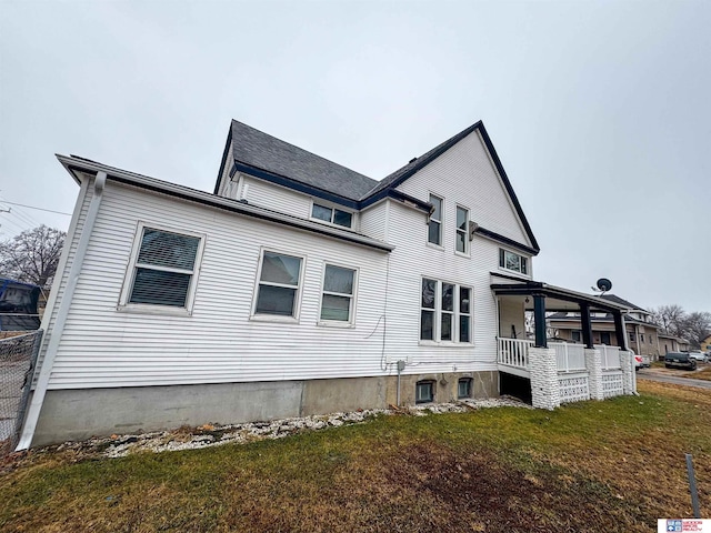 view of home's exterior featuring a lawn and covered porch