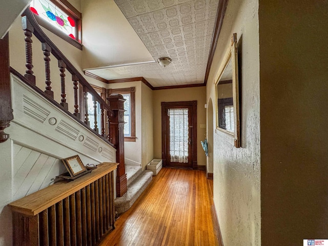 doorway featuring crown molding and wood-type flooring