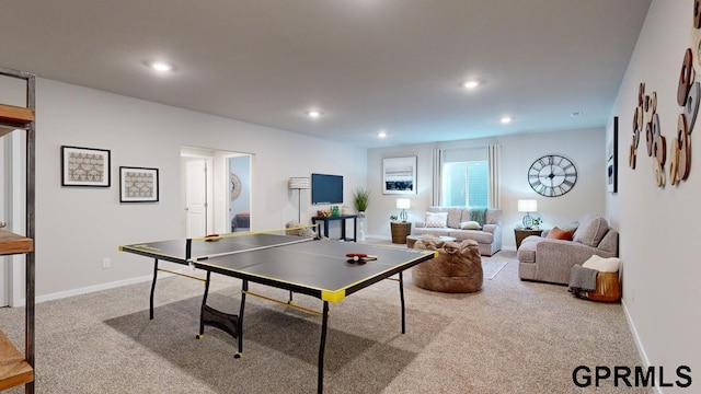 recreation room with light colored carpet