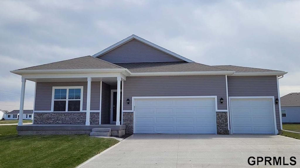 view of front of property with a front yard and a garage