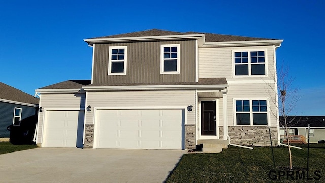 view of front of house with a garage and a front lawn